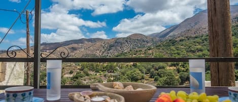 Terrace outside the room with dining table and great mountain views