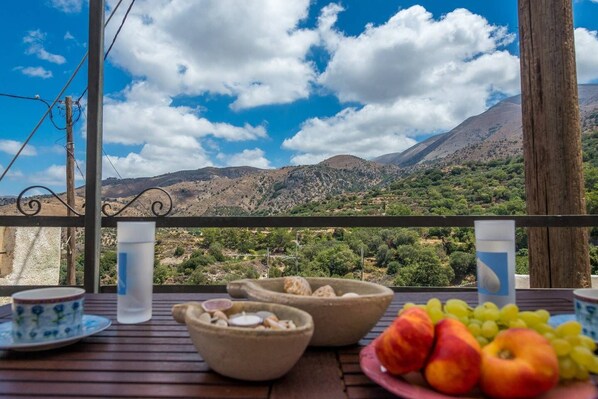 Terrace outside the room with dining table and great mountain views