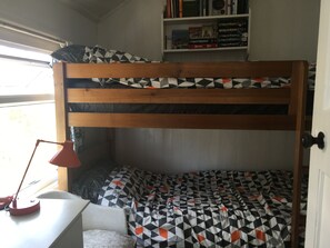 The bedroom with bunkbeds with chest of drawers and wardrobe.