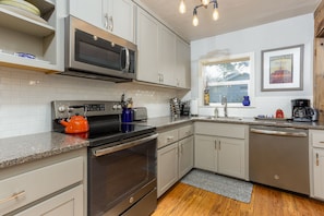 Fully stocked kitchen with all dishes, cookware and appliances for convenience