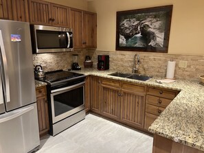 Kitchen with new porcelain tile in November, 2023