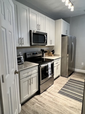 Kitchen with brand new cabinets, stainless steel appliances and granite counters