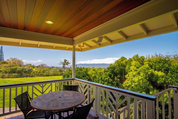 Cozy and sheltered covered deck with dinette seating for four.