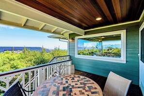 Cozy and sheltered covered deck with dinette seating for four.