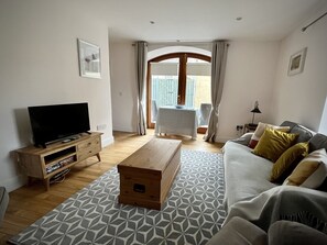 Sitting area with double doors to small patio.