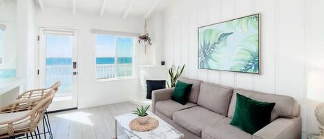 Ocean view living room with original 1940s fireplace (gel fuel provided for guest use)