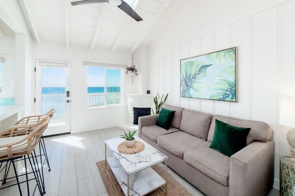 Ocean view living room with original 1940s fireplace (gel fuel provided for guest use)