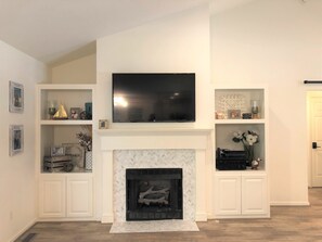 Gas Fireplace and Flat Screen TV located in the Living Room. 