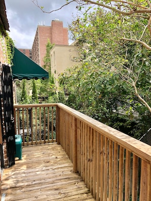 Private patio overlooking courtyard.  Two chairs and table have been added.