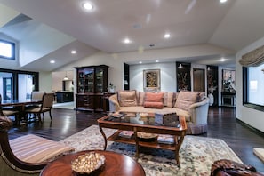 The spacious living room is open to the informal and formal dining room.