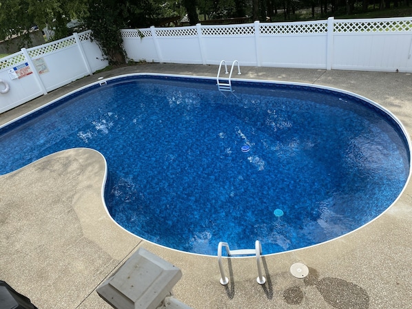 Private sparkling pool with propane barbecue overlooking lush land and the lake 