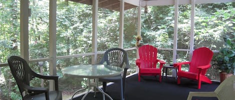 Enjoy the year round creek from this screened porch