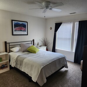 Master Bedroom has two windows, darkening blinds, and ceiling fan.