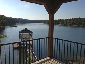 View looking left from deck toward new boathouse with swim pier and boat lift.