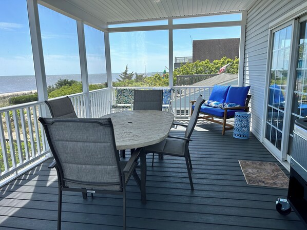 Screened in deck with beautiful views of the beach!