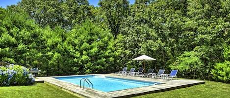 Spacious, sunlit pool area with private, professionally landscaped grounds.