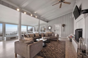 Living room with a huge TV and a fireplace