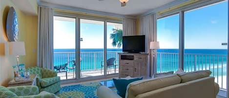 wrDual sliding doors to access the wraparound balcony with ocean and sunset view