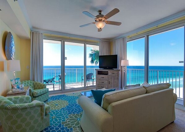 wrDual sliding doors to access the wraparound balcony with ocean and sunset view