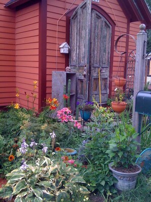 Flowers aplenty in summer by the front door. 