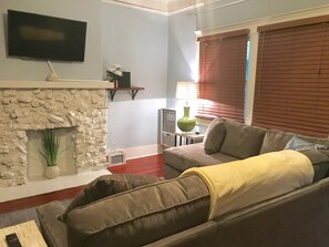 Living room with Full bed that has a  memory foam mattress  In couch bed. 