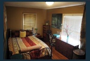 Rm.#1 'The Art Room'. Queen bed, closet, mirrors, beautiful art.