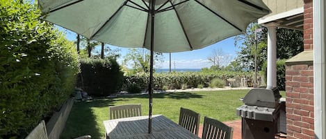 Grill and outdoor dining area with umbrella