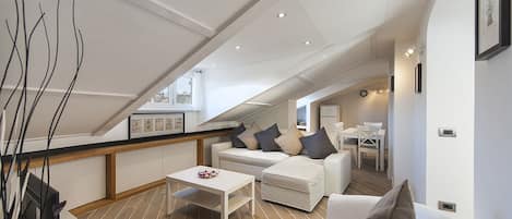 BRIGHT LIVING ROOM with panoramic windows. Sofa bed , armchair and TV. 