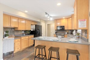 House 2 fully equipped kitchen with bar seating for 3