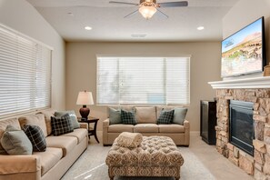 Spacious family room nice sofas, fireplace and large TV to gathe