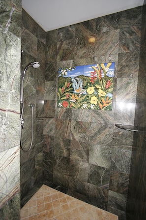Stone shower with hand-painted ceramic tiles by local artist.