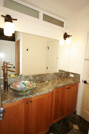 Modern bathroom with hand-painted sink and granite.