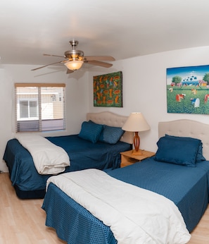 Cozy bedroom shows new beds with addition of twin bed. 