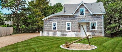 The front yard, the house and the driveway.