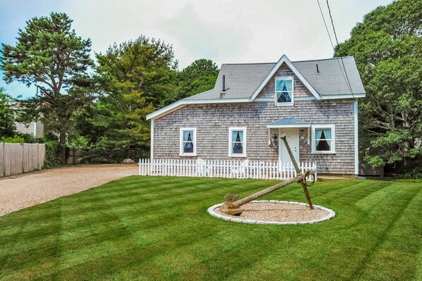 The front yard, the house and the driveway.