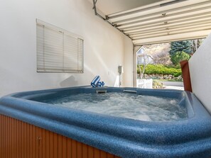 Private hot tub in garage out of the elements