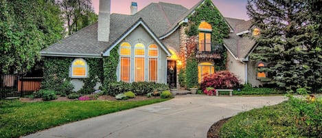 Chateau with river rock facade, gardens and circular driveway