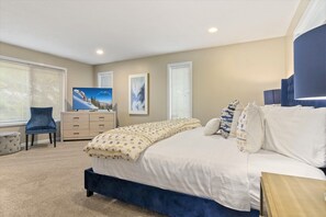 Master bedroom with gorgeous king bed, dresser, TV, 2 chairs