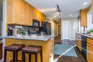 Beautiful kitchen with slate floor and peninsula bar seating