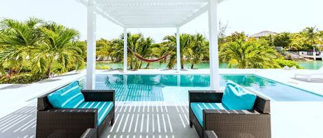 Patio, pool, canal view - I Land Time Villa in Leeward, Providenciales