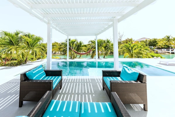 Patio, pool, canal view - I Land Time Villa in Leeward, Providenciales