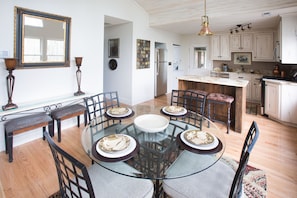 Dining area with vaulted ceilings and tons of light overlooking the beautiful, natural yard