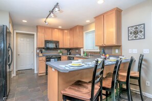 Beautiful spacious kitchen with bar seating and slate floors