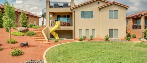 Covered patio with slide and roof-top deck overlooking pools