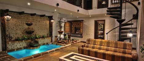 Relaxation living room overlooks waterfall and in-floor jacuzzi.