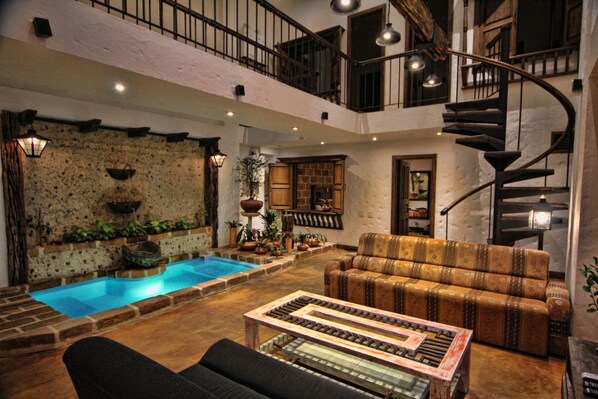 Relaxation living room overlooks waterfall and in-floor jacuzzi.