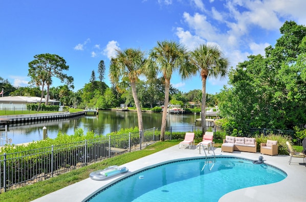 Heated pool and scenic canal right out the back door.  Backyard fully fenced.