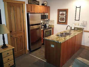 Kitchen with pantry, wine rack, new appliances and granite.