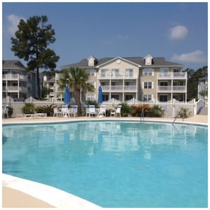 Beautiful pool with workout room and hottub located across the parking lot .