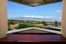 Corner window in living room shows off the views of the West Maui Mountains.